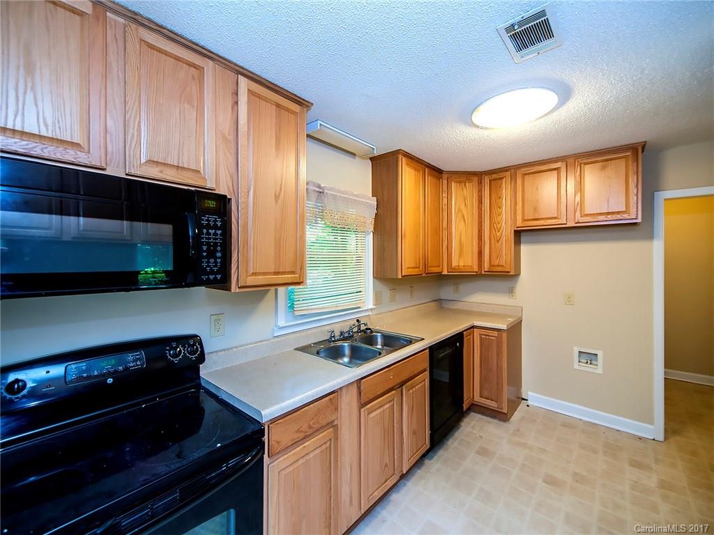 740 Rama Road Charlotte, NC 28211 - Photo 7 of 15 a kitchen with stainless steel appliances granite countertop a stove a sink and a microwave