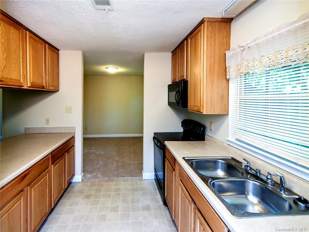 740 Rama Road Charlotte, NC 28211 - Photo 10 of 15 a kitchen with a sink stove top oven and cabinets
