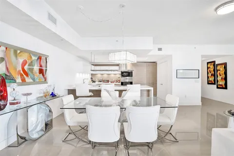 a kitchen with a sink a stove and cabinets
