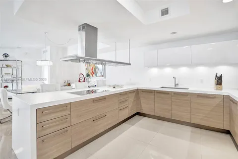 a kitchen with granite countertop white cabinets stainless steel appliances and sink