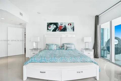 a bedroom with a large bed and a couch