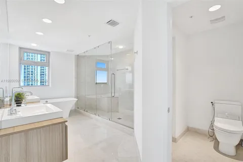 a bathroom with a sink mirror and a bathtub