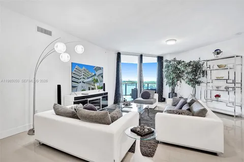 a living room with furniture and a large window