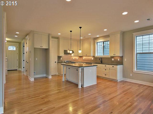 2437 North Alberta Street Portland, OR 97217 - Photo 12 of 16 a large kitchen with granite countertop a large counter top stainless steel appliances and a window
