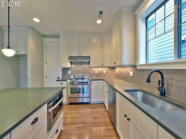2437 North Alberta Street Portland, OR 97217 - Photo 13 of 16 a kitchen with stainless steel appliances granite countertop a sink stove and refrigerator