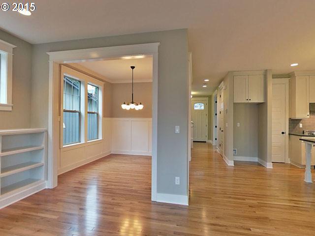 2437 North Alberta Street Portland, OR 97217 - Photo 14 of 16 a view of a big room with wooden floor windows and a kitchen