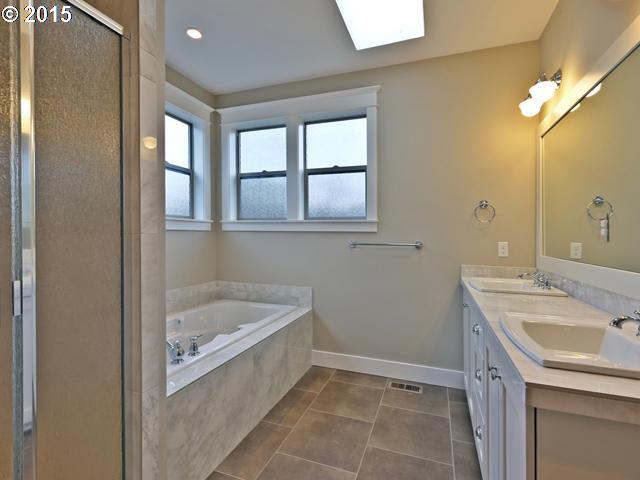 2437 North Alberta Street Portland, OR 97217 - Photo 7 of 16 a bathroom with a tub sink and mirror