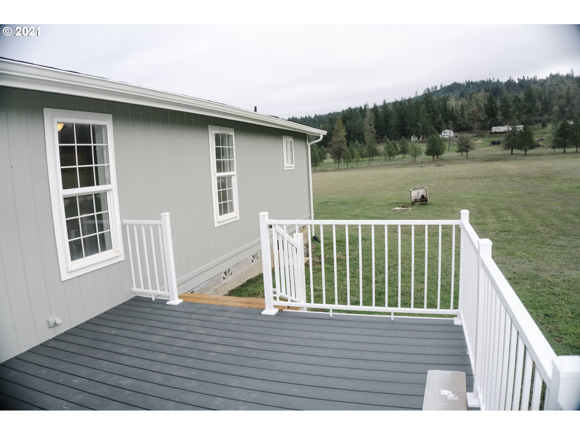 449 Fir Vista Road Sutherlin, OR 97479 - Photo 12 of 32 a view of balcony with wooden floor and lake view