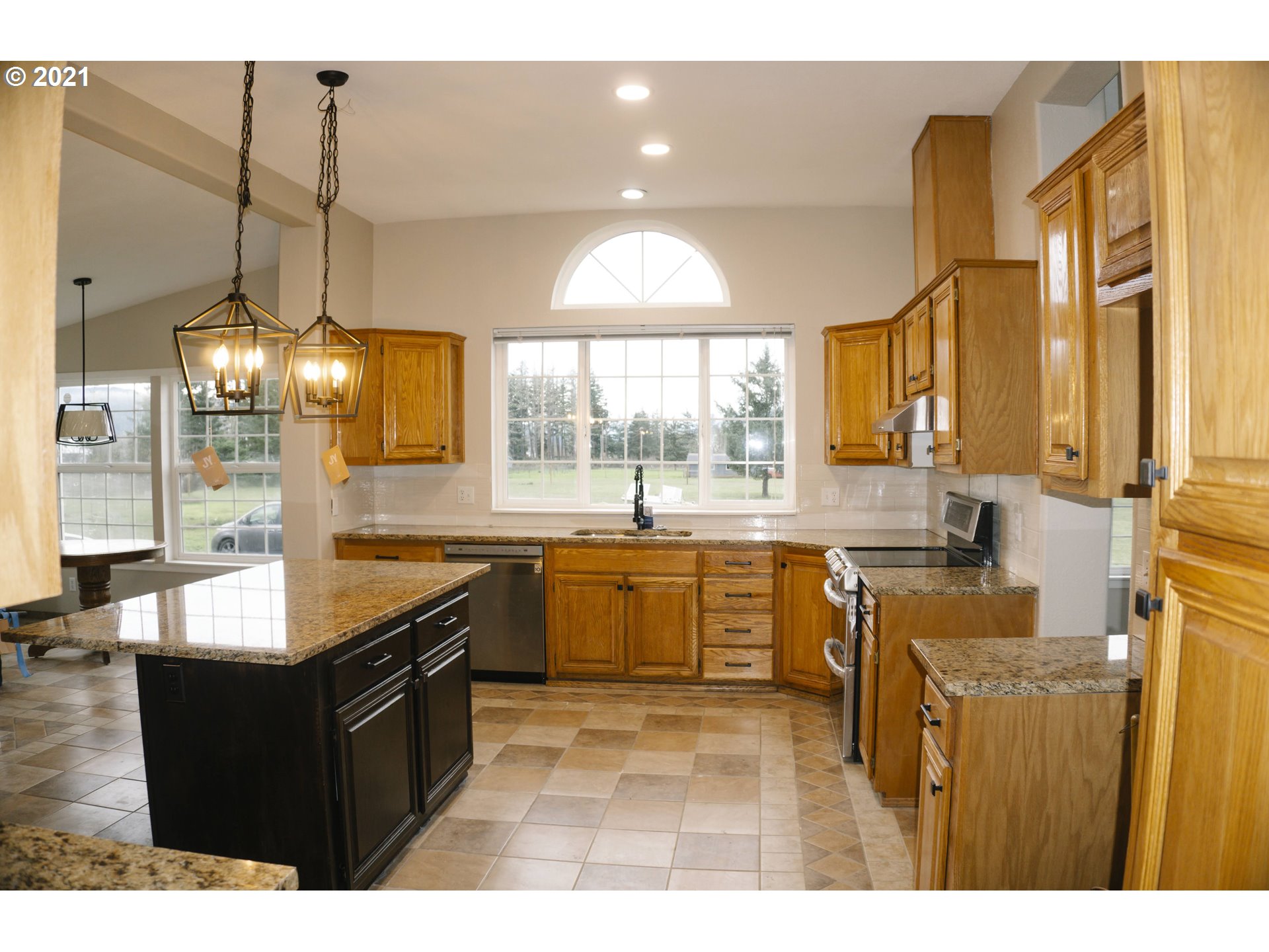 449 Fir Vista Road Sutherlin, OR 97479 - Photo 15 of 32 a kitchen with granite countertop a stove a sink and a wooden floors