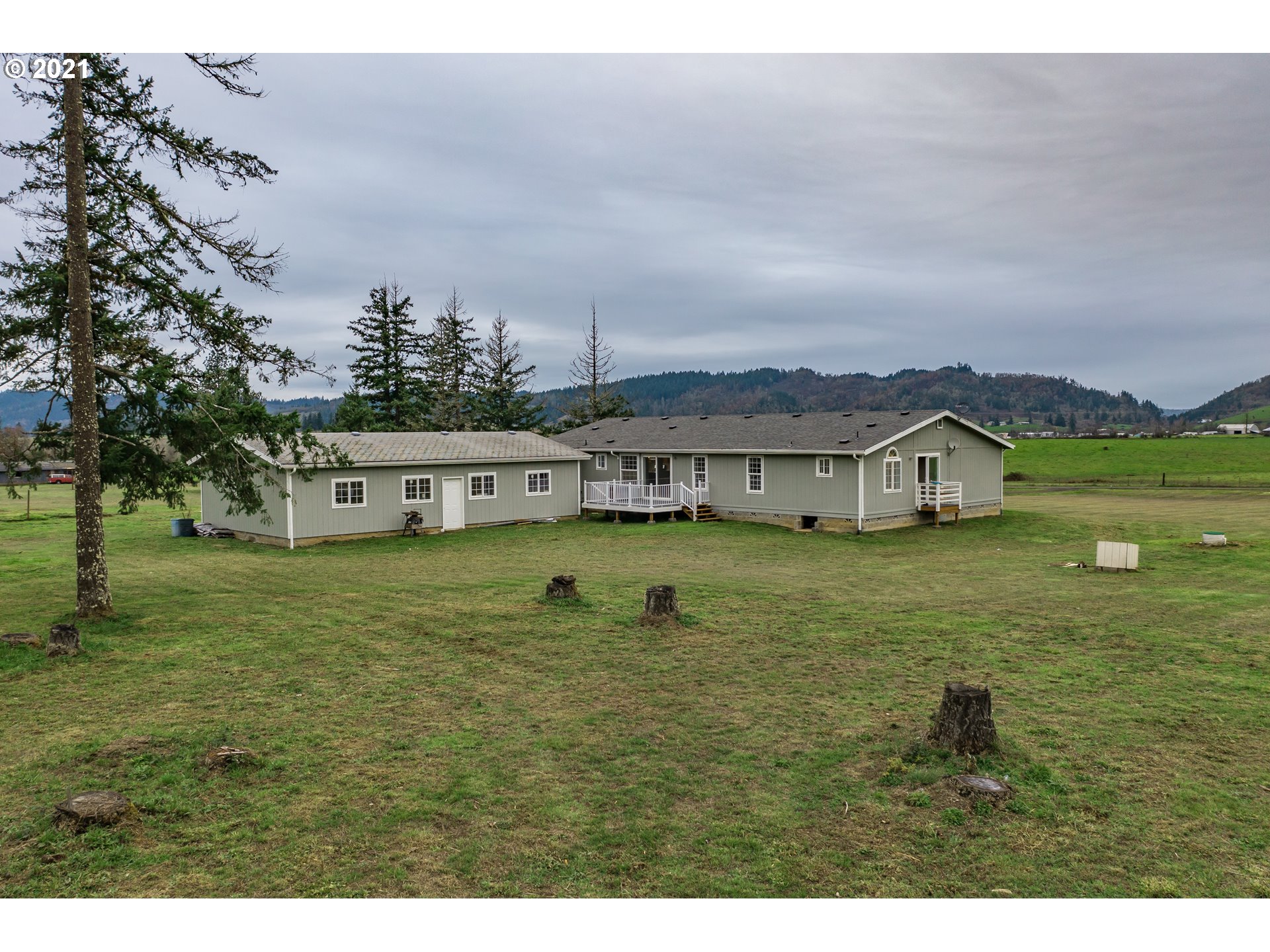 449 Fir Vista Road Sutherlin, OR 97479 - Photo 8 of 32 a view of a big house with a big yard and large trees