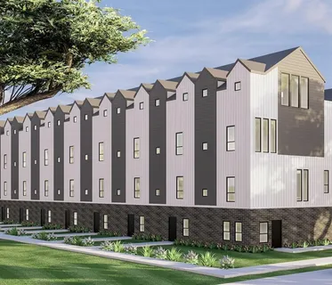 a large brick building with a yard in front of it