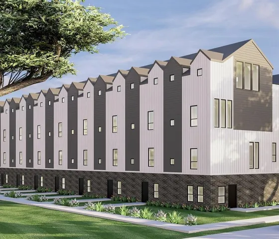 a large brick building with a yard in front of it