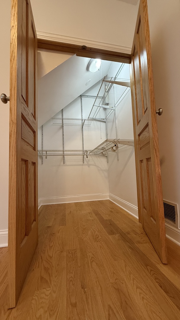 2216 North Central Avenue, Unit 1 Chicago, IL 60639 - Photo 11 of 28 an empty room with wooden floor and windows