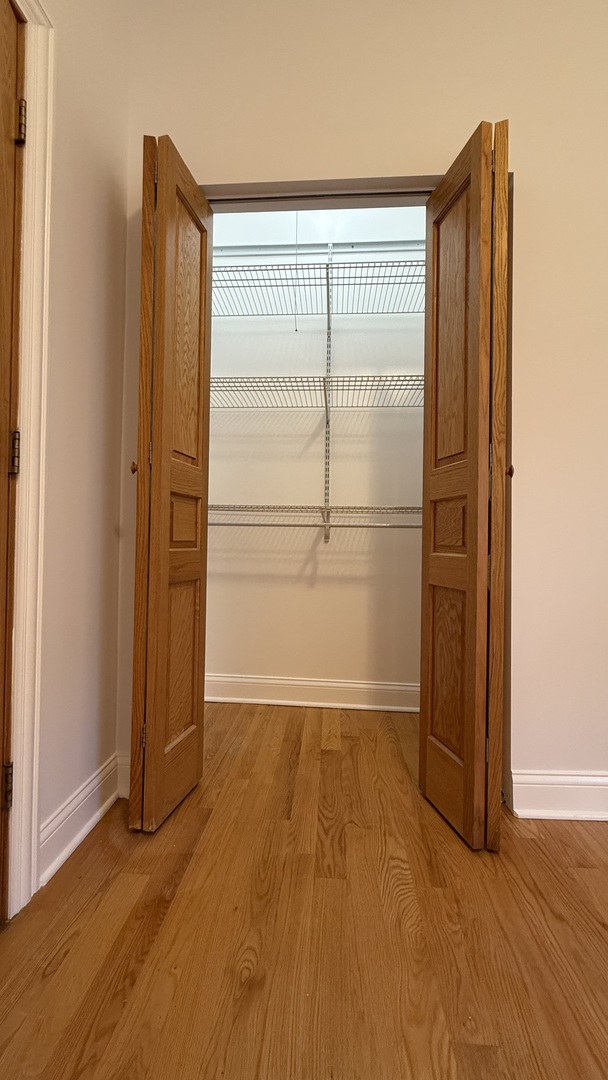 2216 North Central Avenue, Unit 1 Chicago, IL 60639 - Photo 14 of 28 an empty room with wooden floor and a window