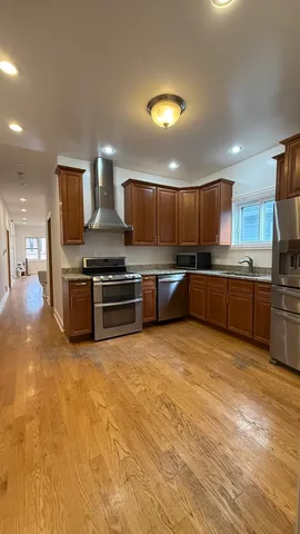 a kitchen with stainless steel appliances granite countertop a stove and a sink