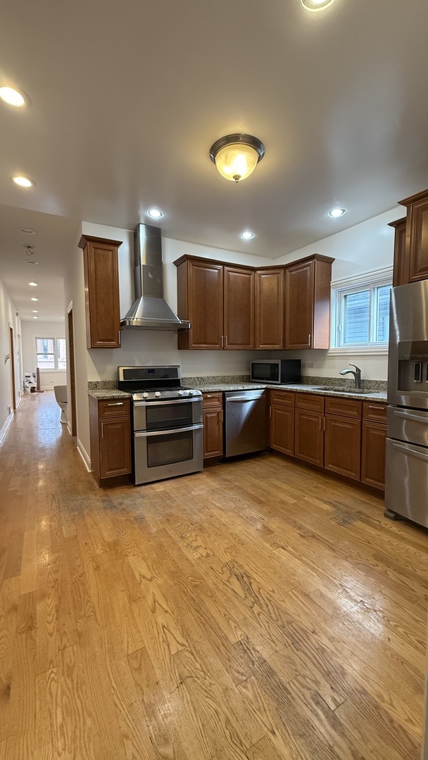 2216 North Central Avenue, Unit 1 Chicago, IL 60639 - Photo 19 of 28 a kitchen with stainless steel appliances granite countertop a stove and a sink