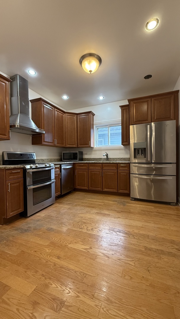 2216 North Central Avenue, Unit 1 Chicago, IL 60639 - Photo 20 of 28 a kitchen with stainless steel appliances granite countertop a stove top oven a sink and a refrigerator