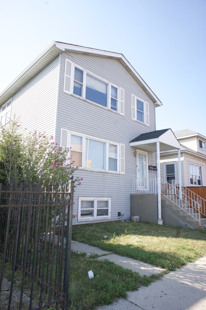 2216 North Central Avenue, Unit 1 Chicago, IL 60639 - Photo 28 of 28 a front view of a house with a yard and garage