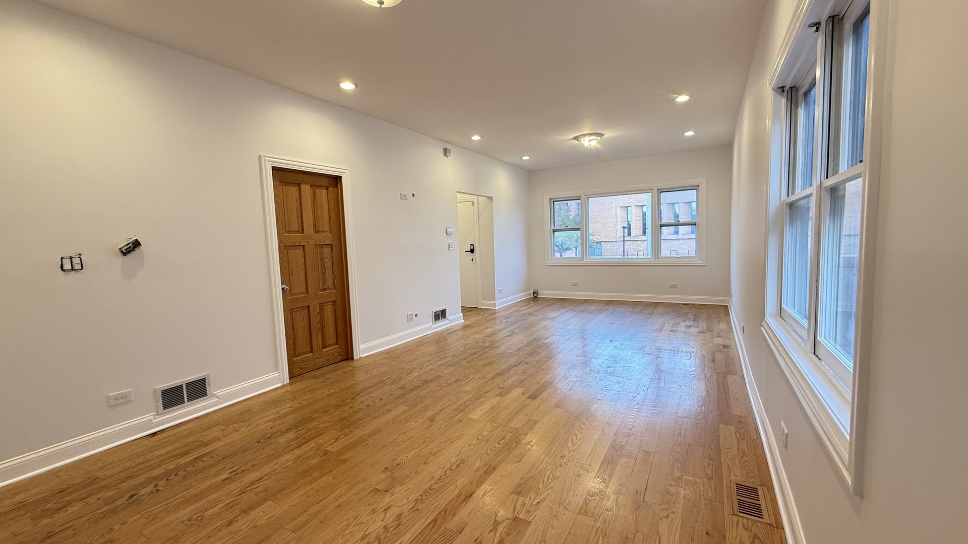 2216 North Central Avenue, Unit 1 Chicago, IL 60639 - Photo 6 of 28 a view of hallway with a large window and wooden floor