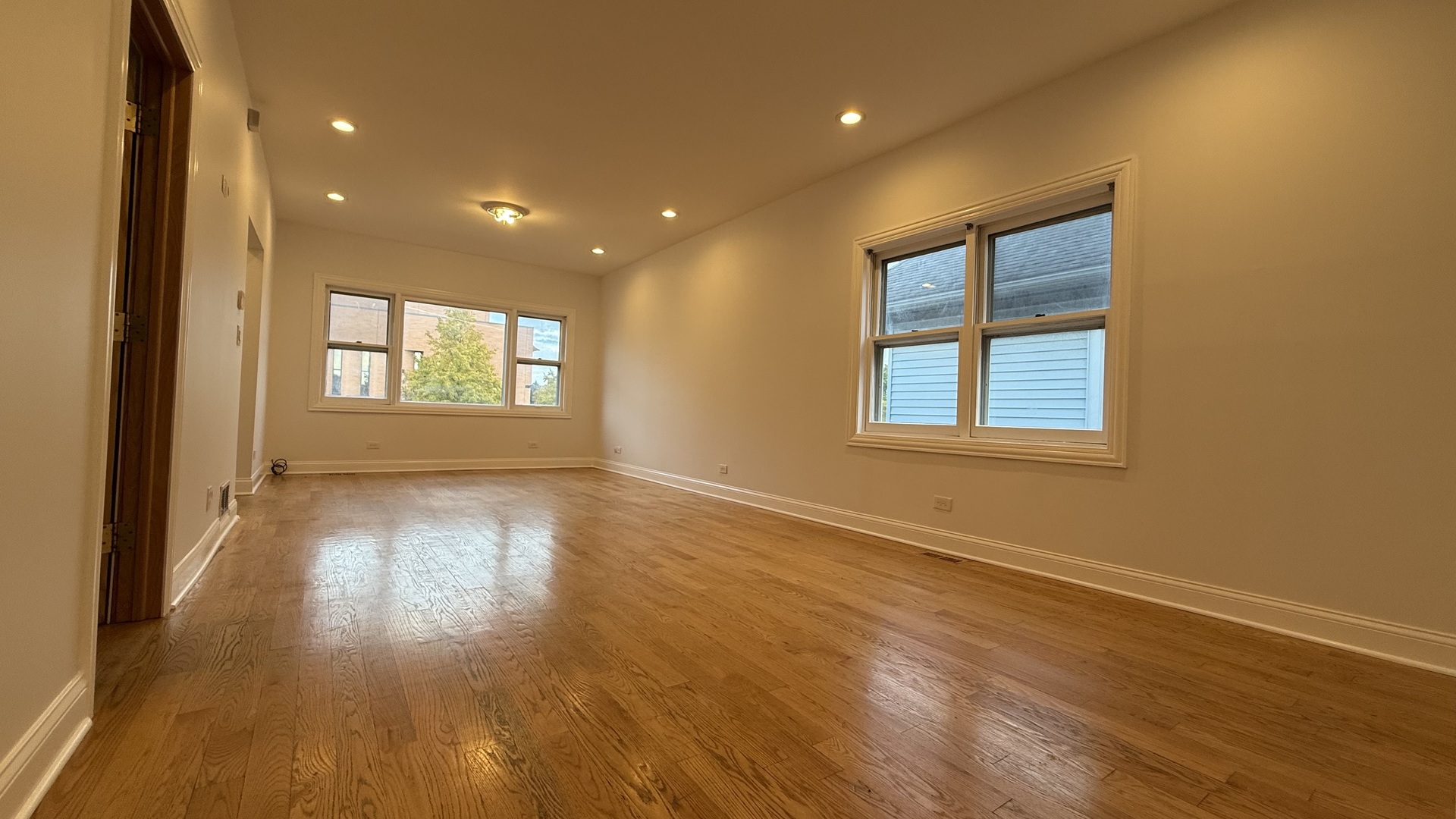2216 North Central Avenue, Unit 1 Chicago, IL 60639 - Photo 7 of 28 a view of an empty room with wooden floor and a window