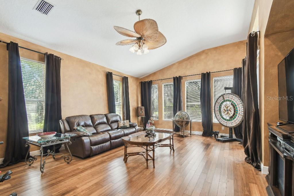 3402 Stonebridge Trail Valrico, FL 33596 - Photo 12 of 17 a living room with furniture a large window and wooden floor