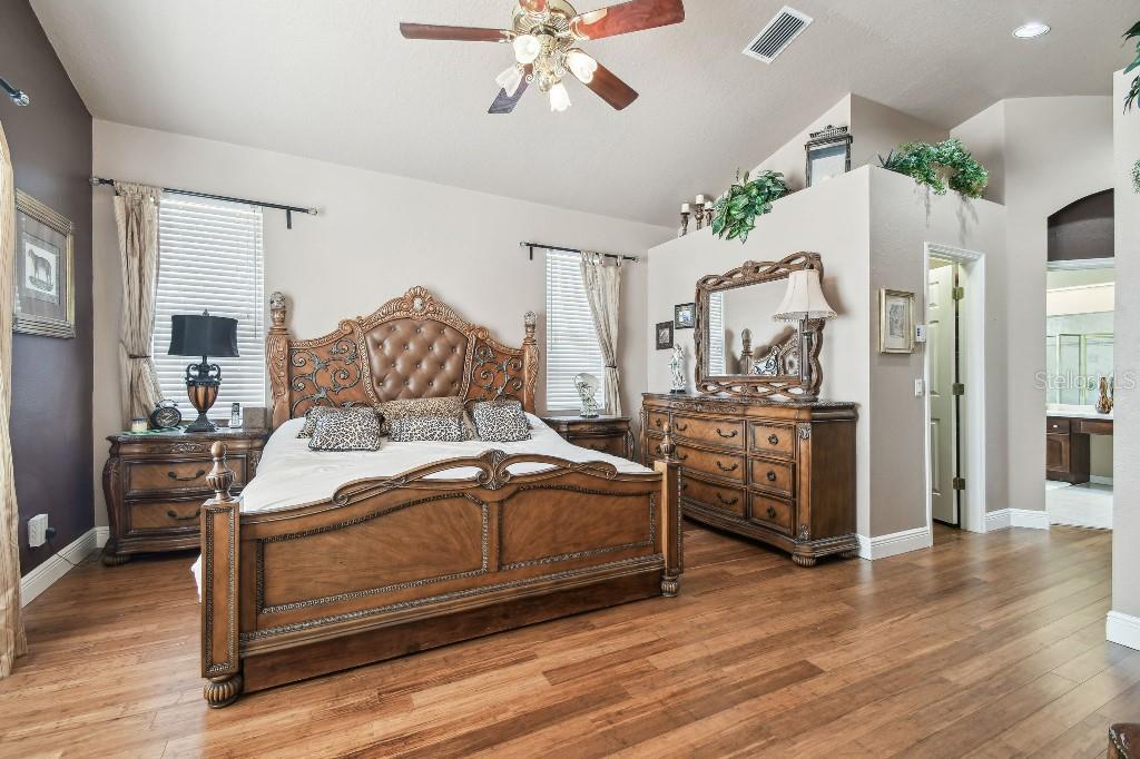 3402 Stonebridge Trail Valrico, FL 33596 - Photo 15 of 17 a bedroom with a bed and wooden floor