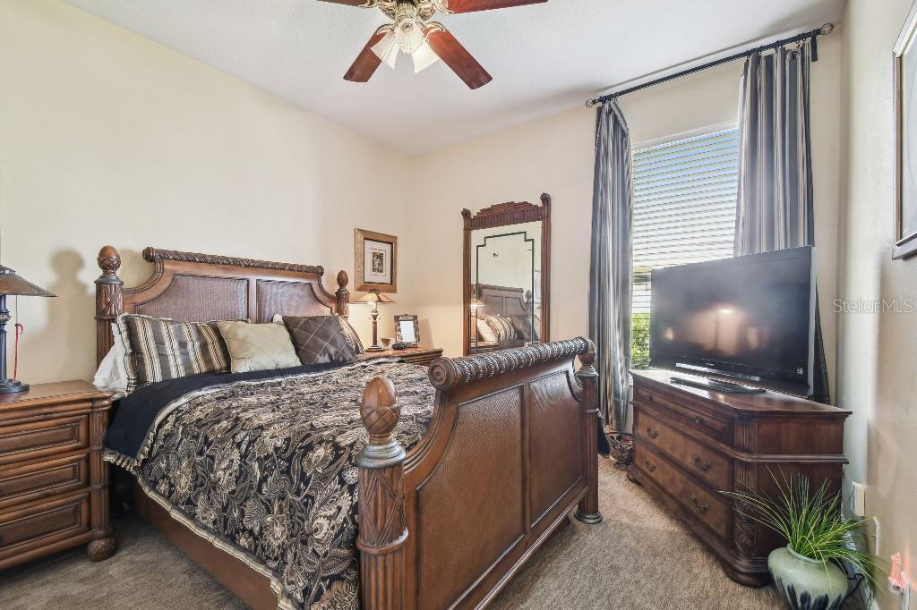 3402 Stonebridge Trail Valrico, FL 33596 - Photo 4 of 17 a bedroom with a bed and a flat screen tv