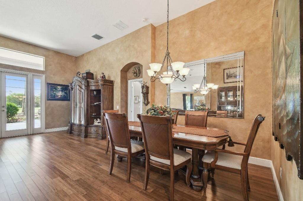 3402 Stonebridge Trail Valrico, FL 33596 - Photo 5 of 17 a dining room with furniture a chandelier and wooden floor