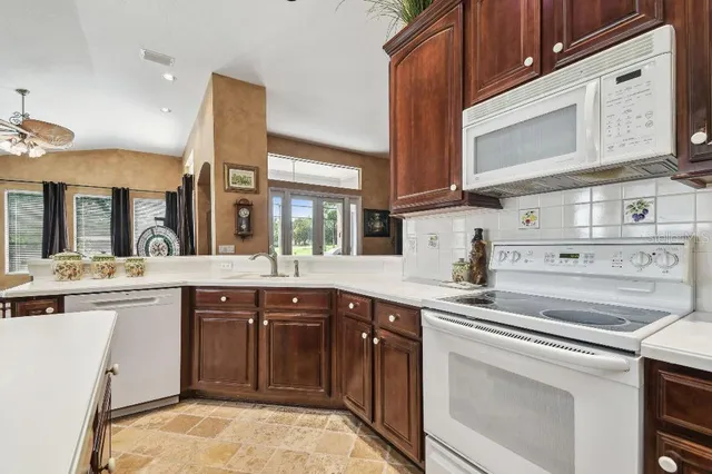 a kitchen with a sink stove and cabinets