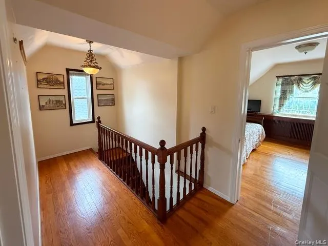 a view of entryway and hall with wooden floor