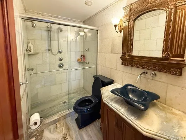 a bathroom with a sink a toilet and shower
