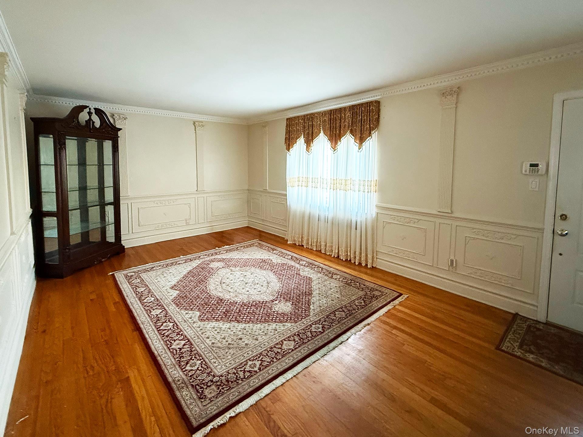 48-22 195th Street Queens, NY 11365 - Photo 4 of 23 a view of an empty room and wooden floor