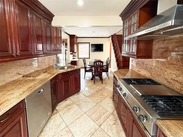 a kitchen with stainless steel appliances granite countertop a stove and a sink