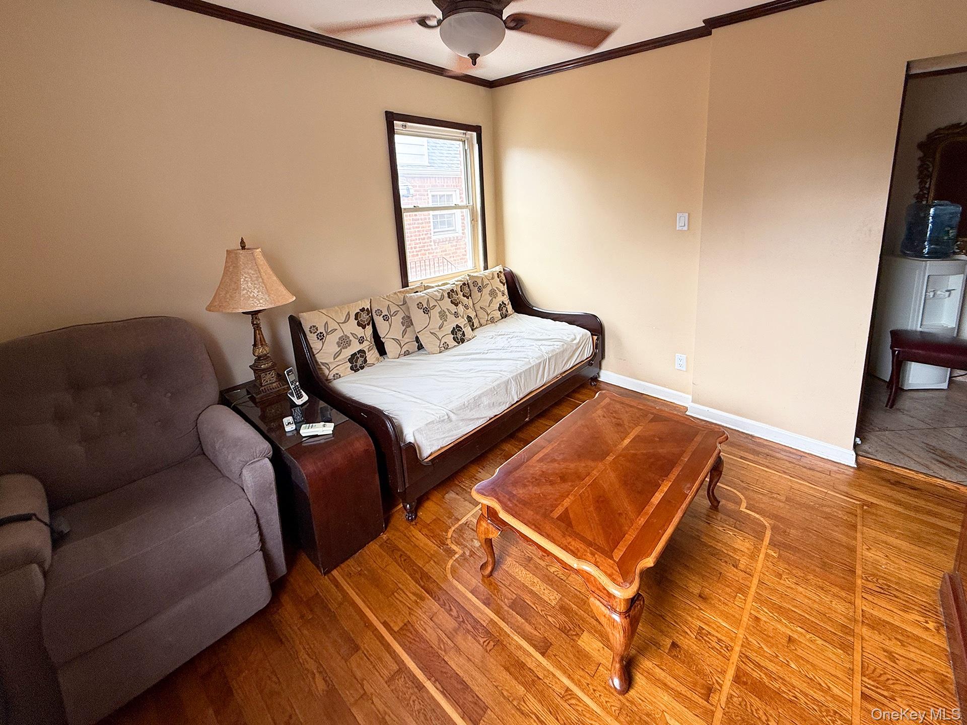 48-22 195th Street Queens, NY 11365 - Photo 9 of 23 a living room with furniture and a window