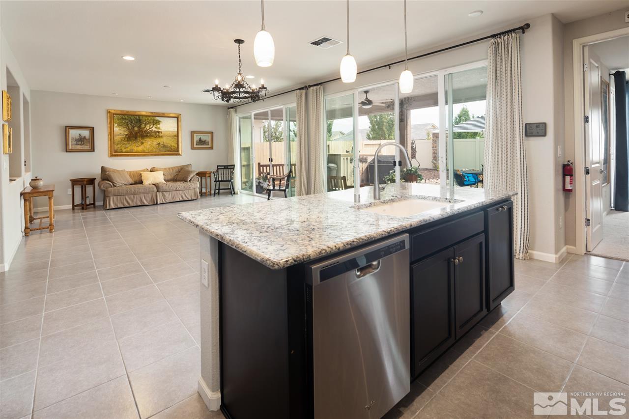 9850 Shadowless Trail Reno, NV 89521 - Photo 3 of 39 a kitchen with center island table and chairs