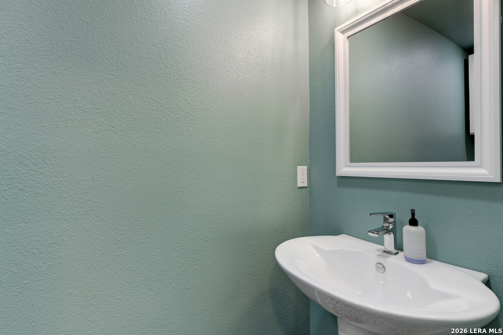 451 Wegener Trail Fischer, TX 78623 - Photo 16 of 43 a bathroom with a sink and a mirror