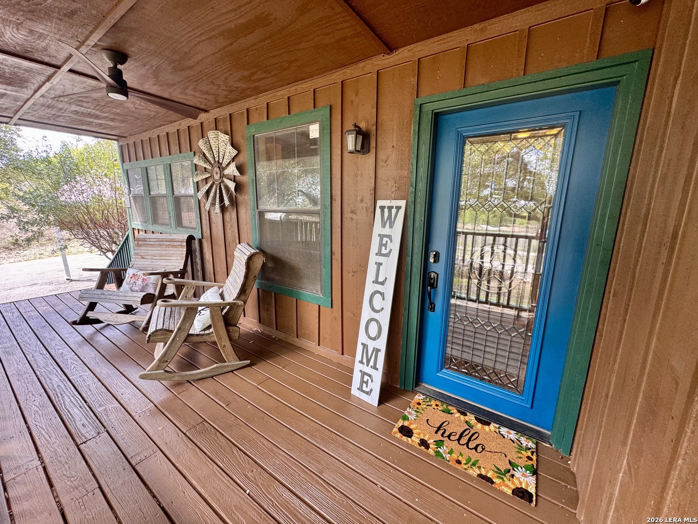 451 Wegener Trail Fischer, TX 78623 - Photo 2 of 43 a view of a balcony with chairs and wooden floor
