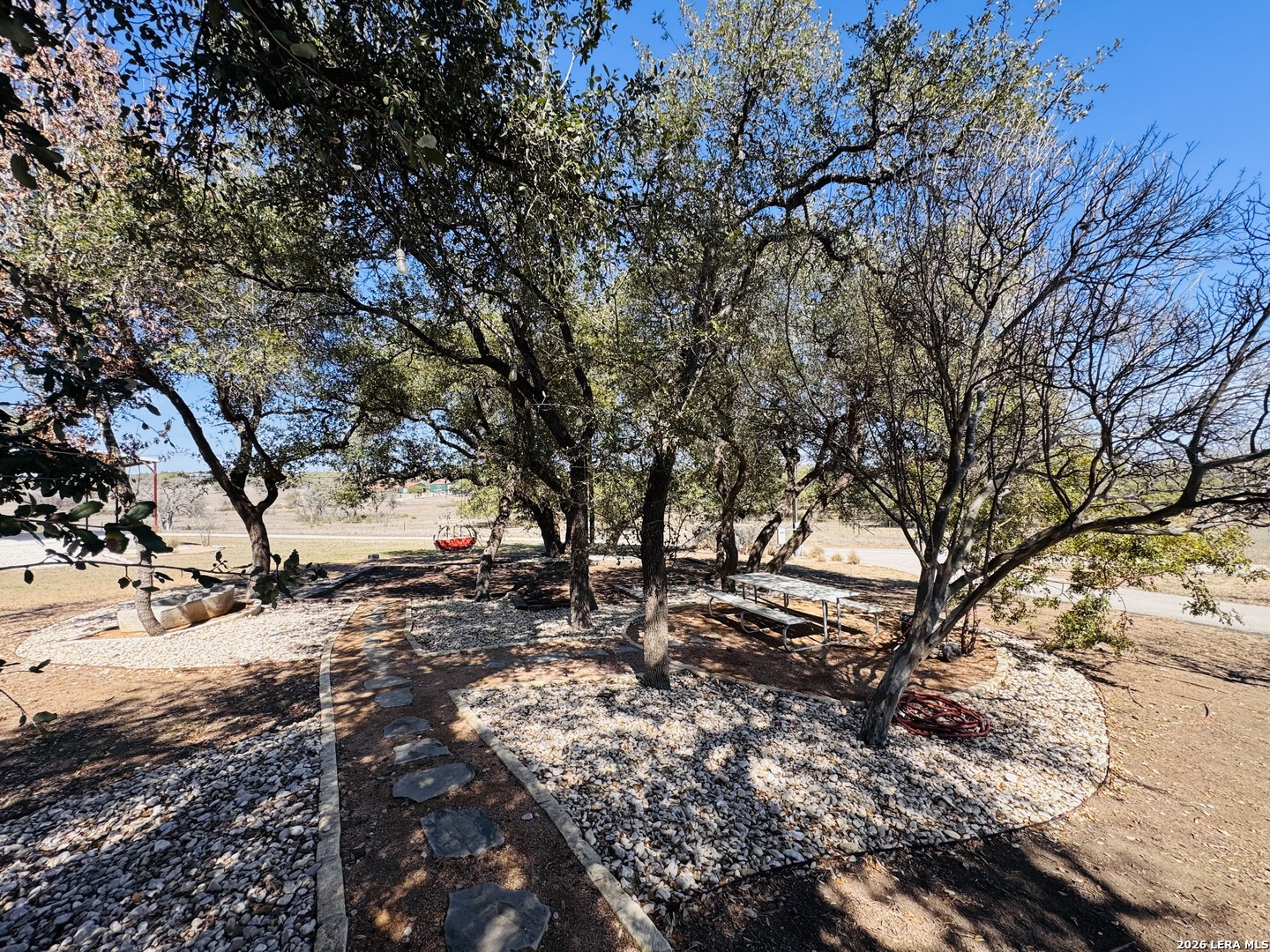 451 Wegener Trail Fischer, TX 78623 - Photo 22 of 43 a backyard of a house with large trees