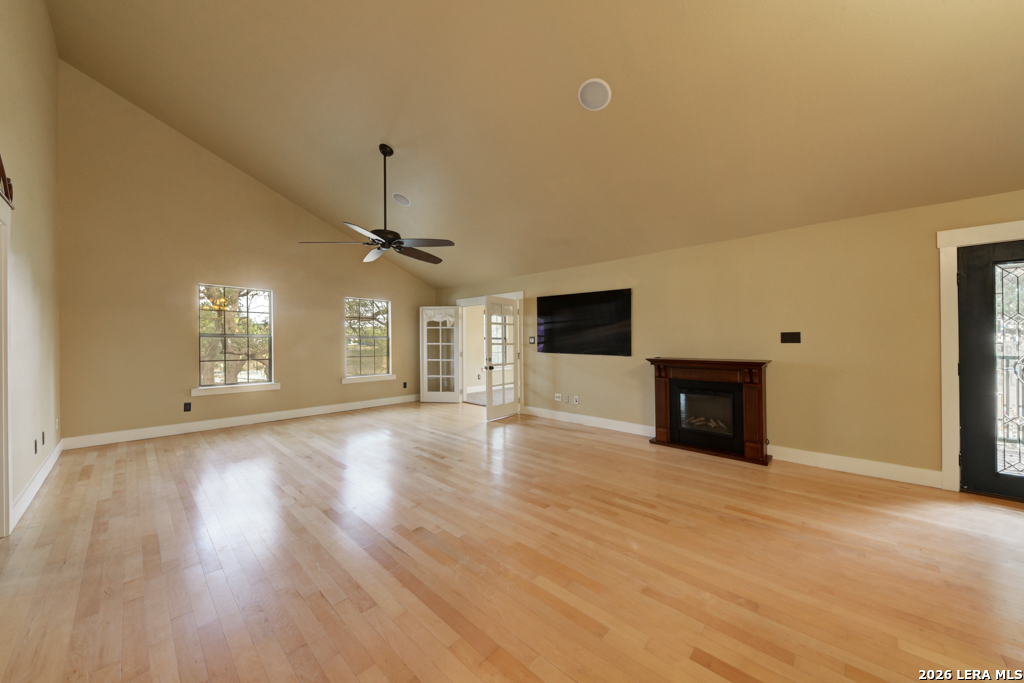 451 Wegener Trail Fischer, TX 78623 - Photo 9 of 43 a view of an empty room with wooden floor and a fireplace
