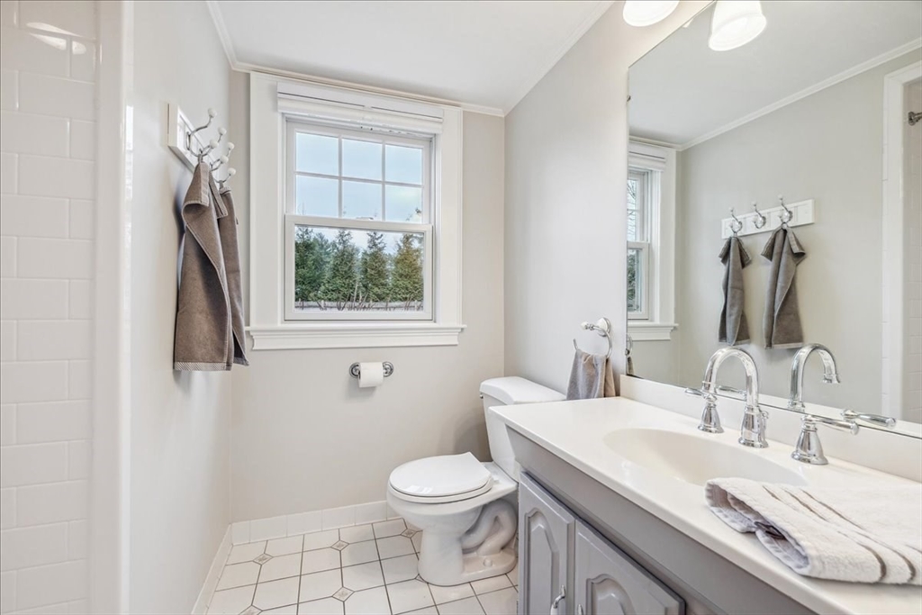 15 Hoover Road Hingham, MA 02043 - Photo 20 of 42 a bathroom with a granite countertop sink toilet a mirror and window