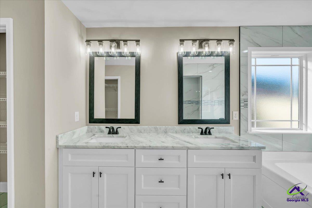 103 Early Drive Byron, GA 31008 - Photo 29 of 56 a bathroom with double sink and a mirror