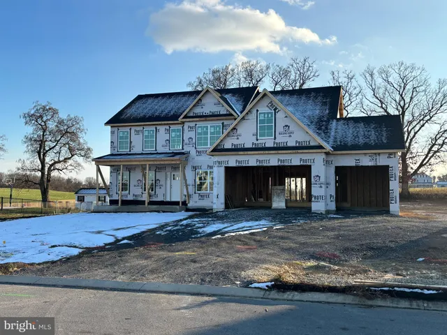 a front view of a house with a garden and yard