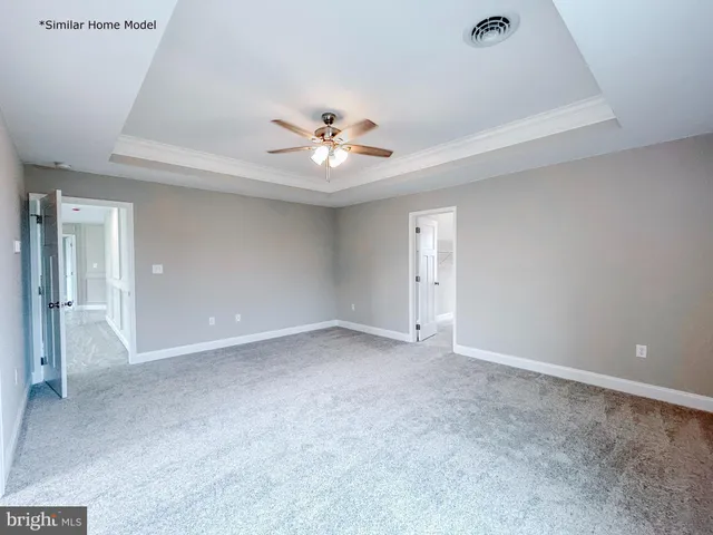 a view of an empty room with a ceiling fan