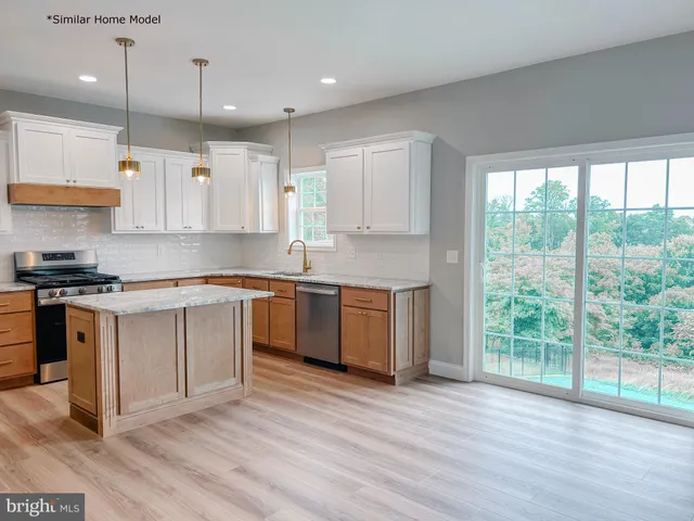 a kitchen with a sink window and cabinets