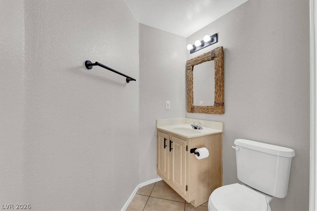 10148 Tree Bark Street Las Vegas, NV 89183 - Photo 13 of 37 A compact and functional bathroom features a single vanity and essential fixtures for convenience.