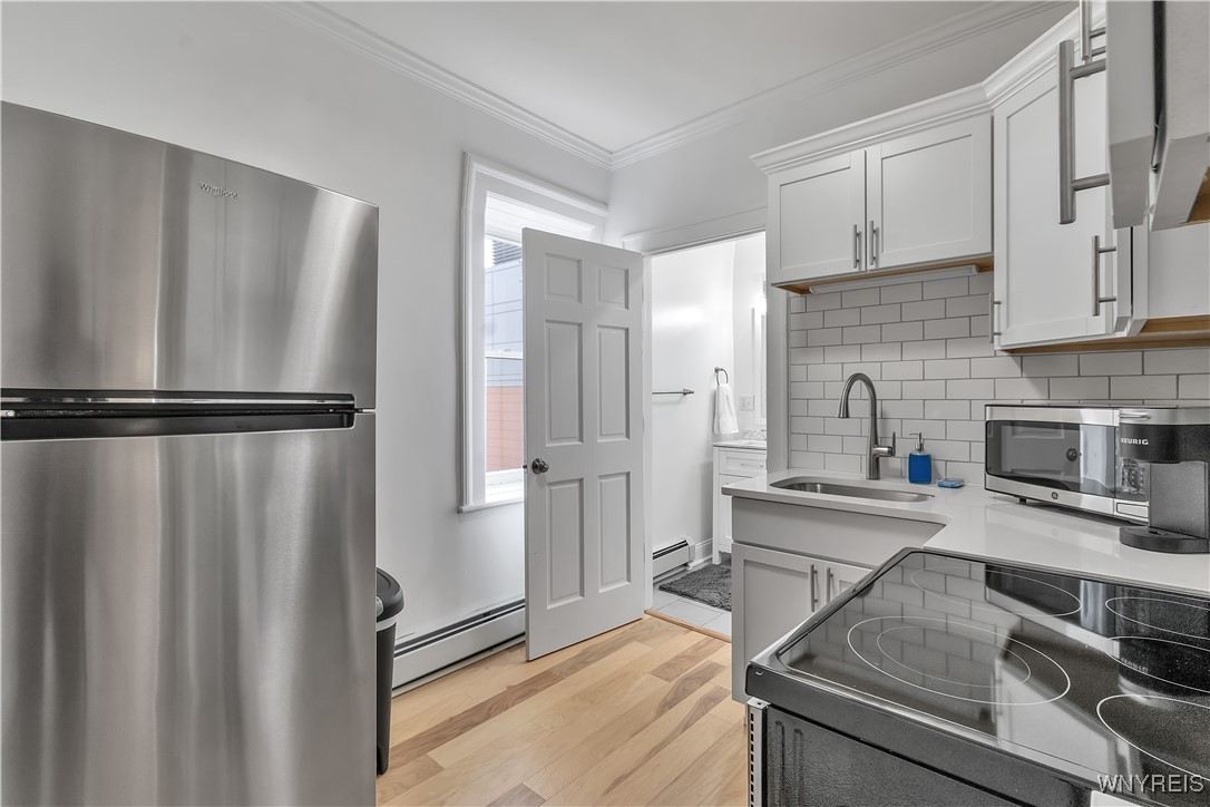 617 Niagara Street, Unit 5 Buffalo, NY 14201 - Photo 11 of 13 Full size fridge, microwave, coffee machine, toast