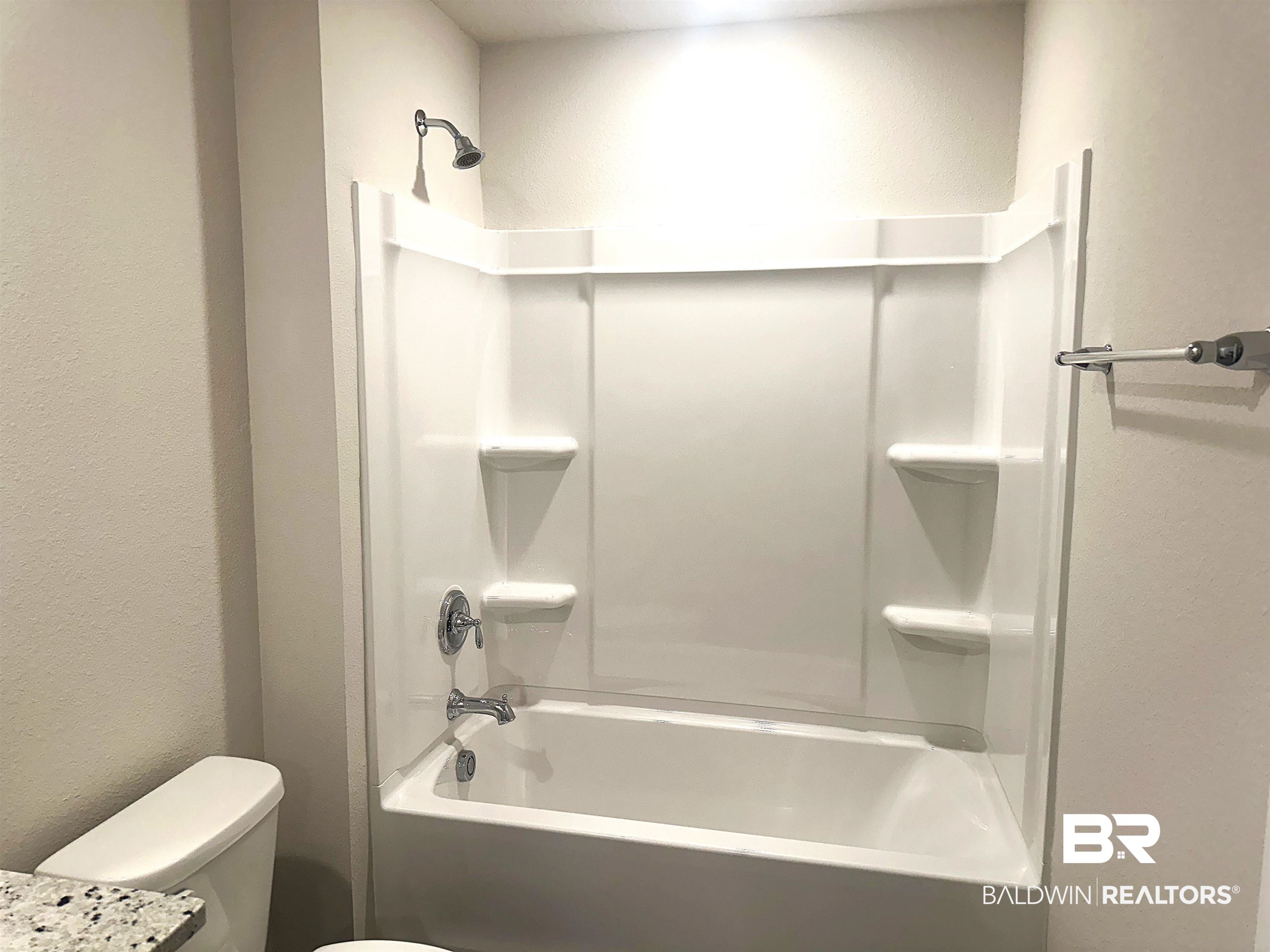 1243 Hayward Loop Foley, AL 36535 - Photo 19 of 32 Bathroom with toilet and bathing tub / shower combination