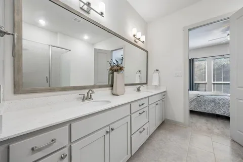 a en suite bathroom with double sink and a mirror