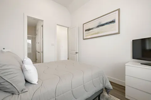 a bedroom with a bed and a flat screen tv