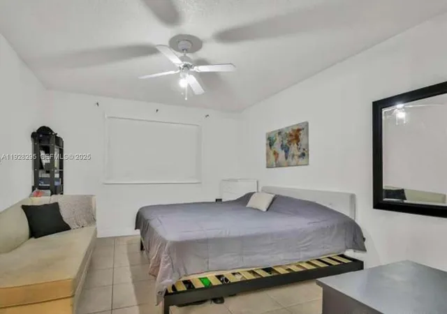 a bedroom with a bed and cabinet